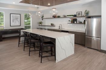 Community kitchen with bar seating and shuffleboard table
